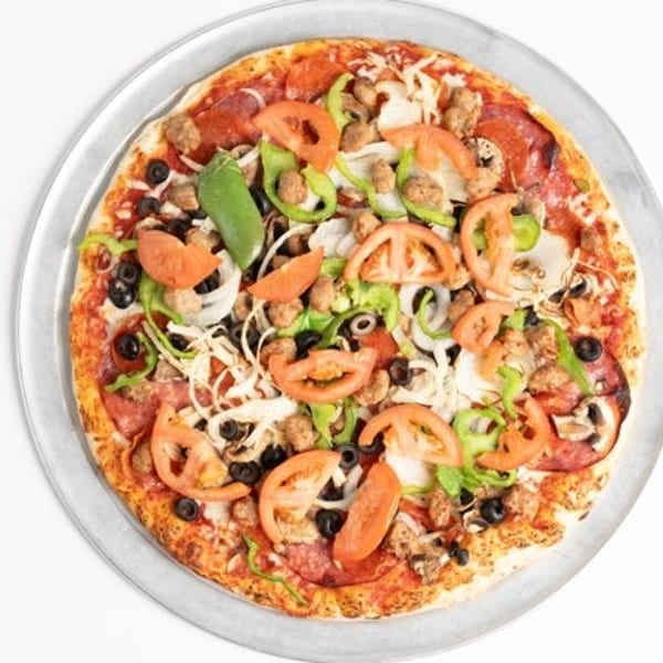Overhead view of a fully loaded pizza with pepperoni, sausage, olives, peppers, onions, and tomatoes.